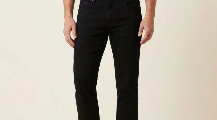 Model wearing black straight-leg jeans with a deep, even black color