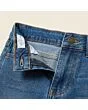 Close-up of the waistband, button and fly on kids' slim jeans