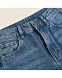 Close-up of the waistband, button and fly on women's barrel jeans