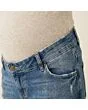 Close-up of the waistband, button and fly on women's maternity jeans