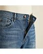 Close-up of the waistband, button and fly on men's relaxed jeans