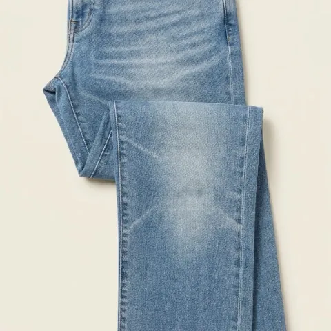 Close-up of light whiskering across the hip of mid-wash jeans