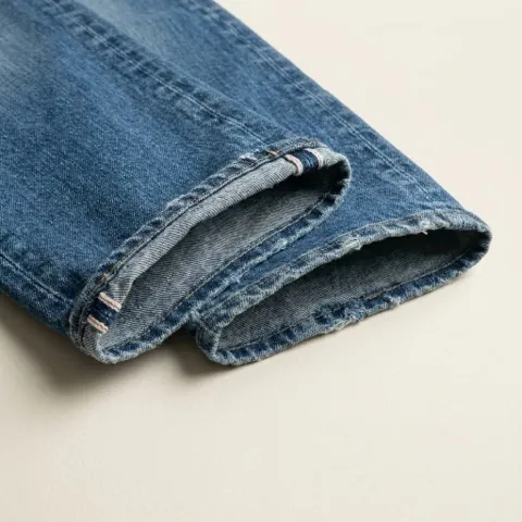 Close-up of a chain-stitched denim hem with looped stitching