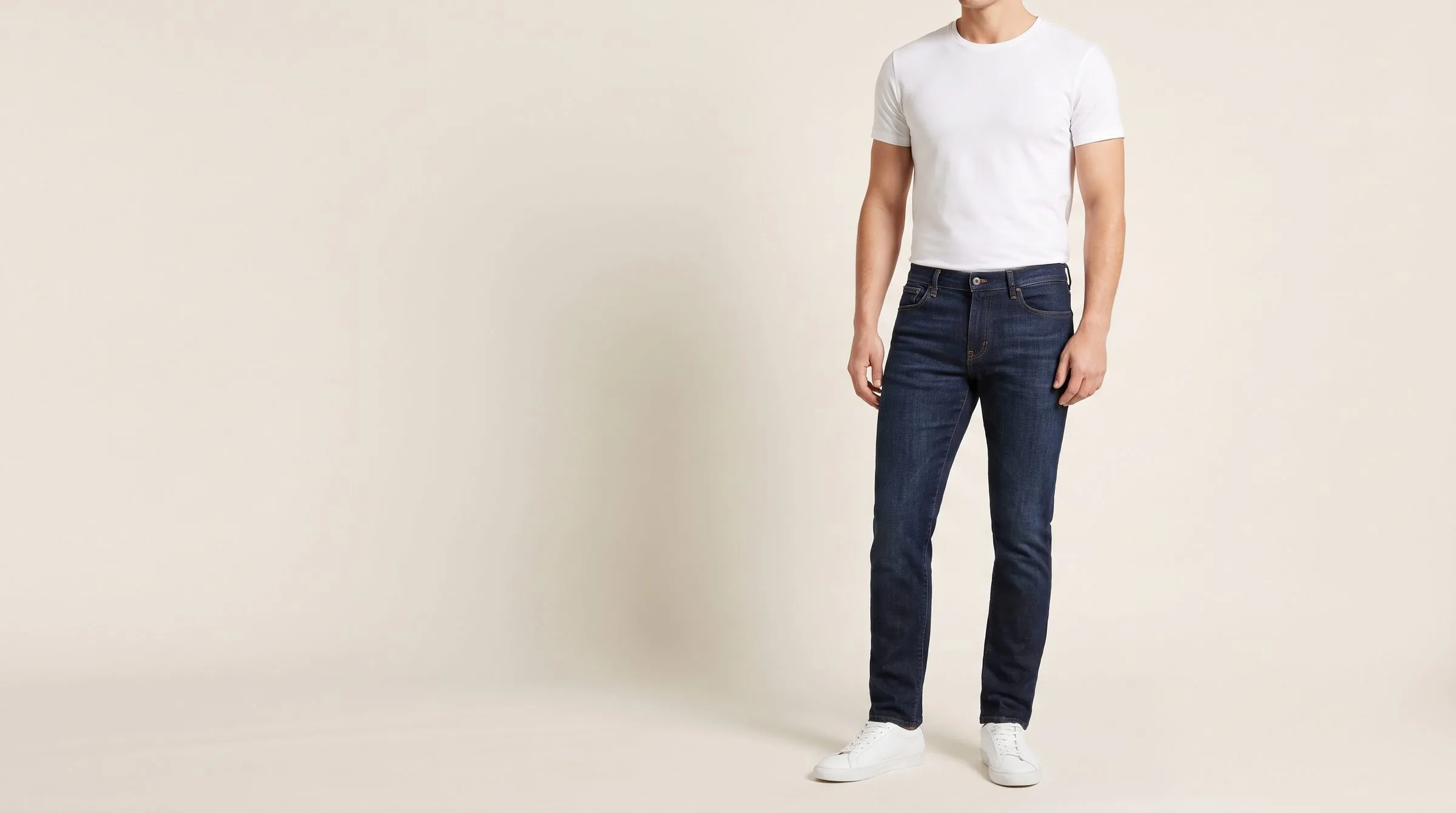 Three pairs of men's jeans in slim, straight and bootcut legs lined up on a cutting table