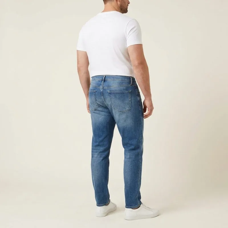 Athletic Taper jeans worn by a man with an inverted trapezoid body shape, back view