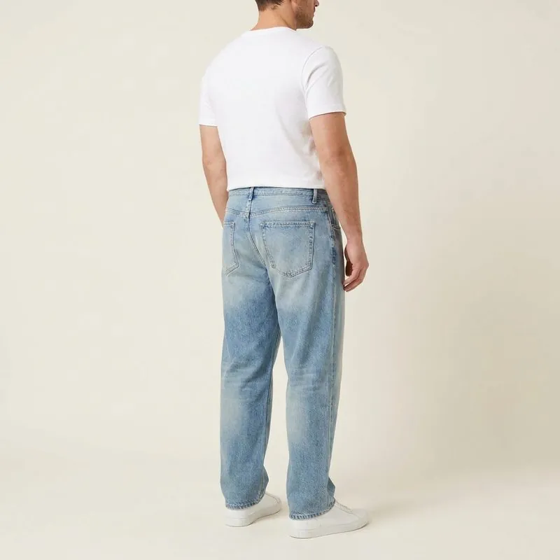 Relaxed jeans worn by a man with an inverted trapezoid body shape, back view