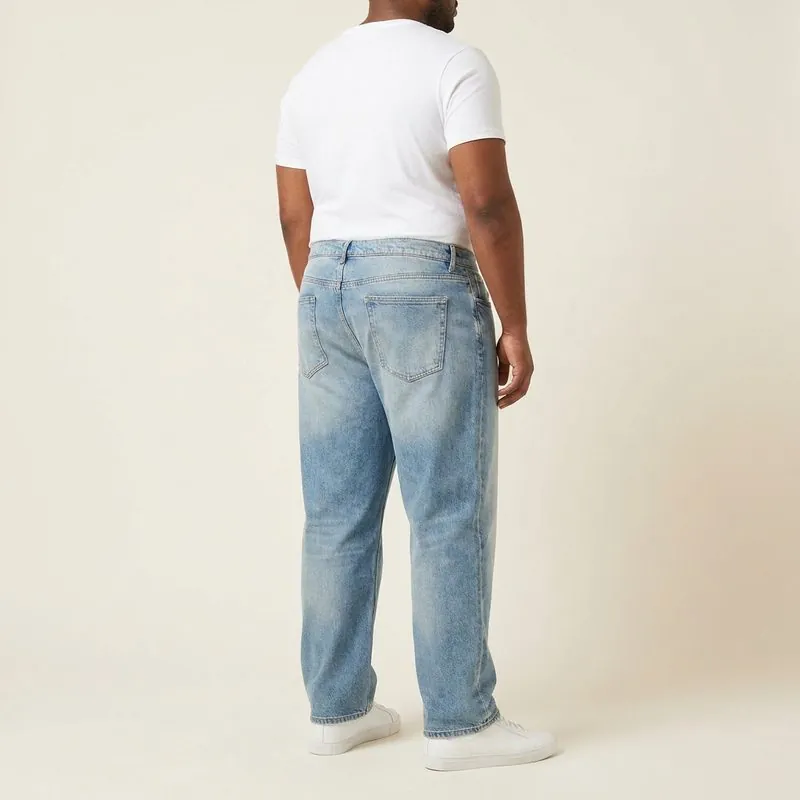 Relaxed jeans worn by a man with an oval body shape, back view