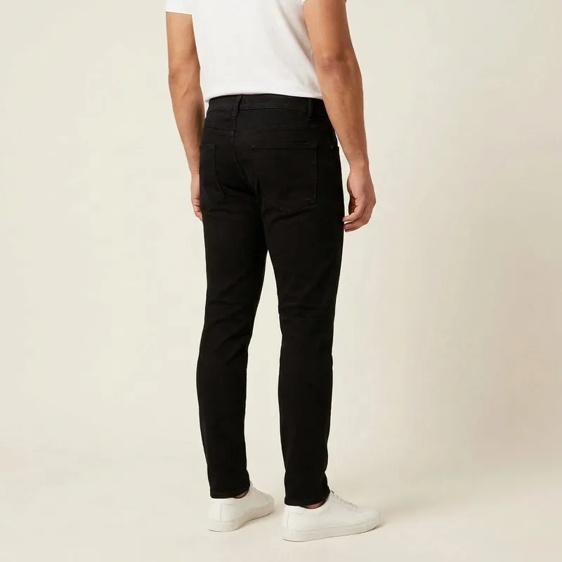 Slim jeans worn by a man with a trapezoid body shape, back view