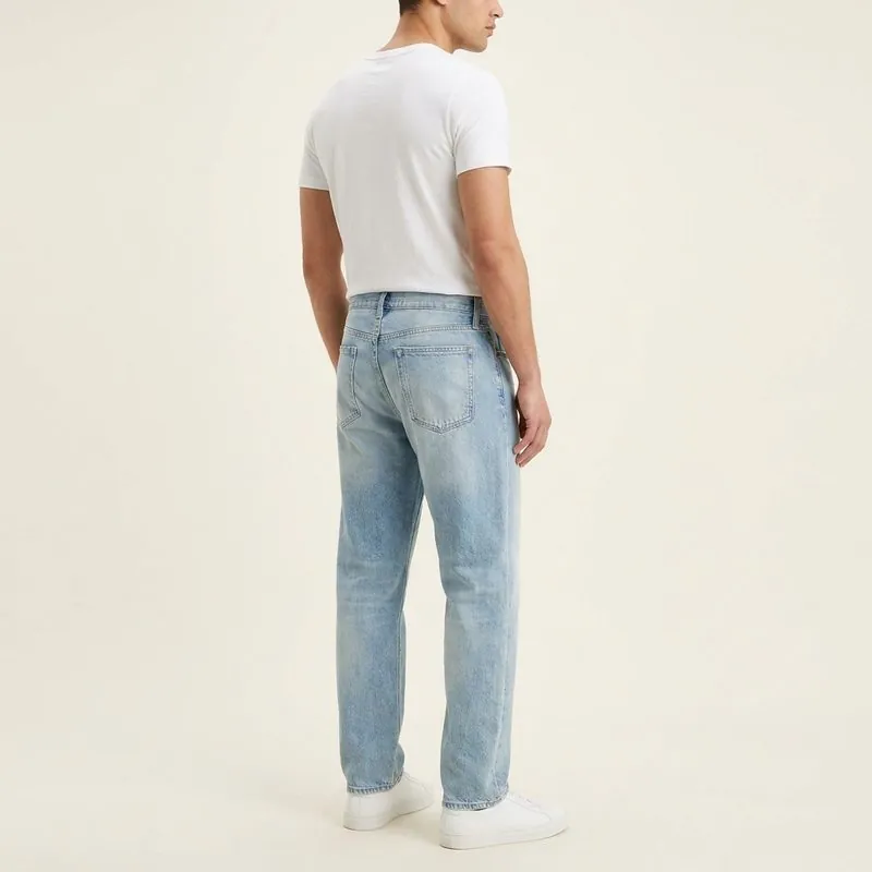 Relaxed jeans worn by a man with a triangle body shape, back view