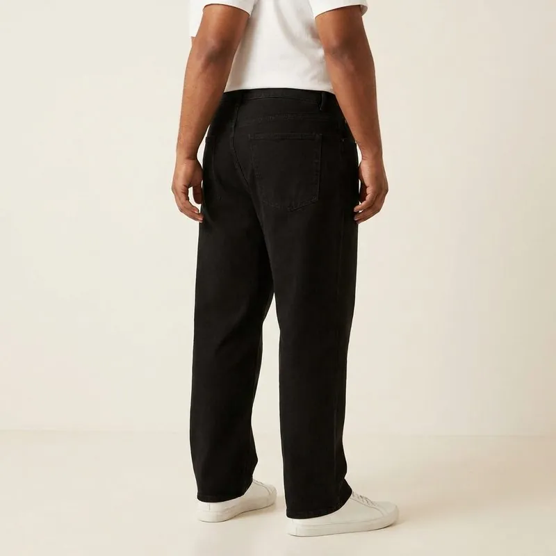 Relaxed jeans worn by a man with an endomorph body type, back view