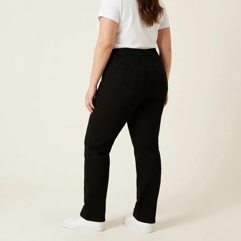 Straight jeans worn by a woman with a barrel body shape, back view