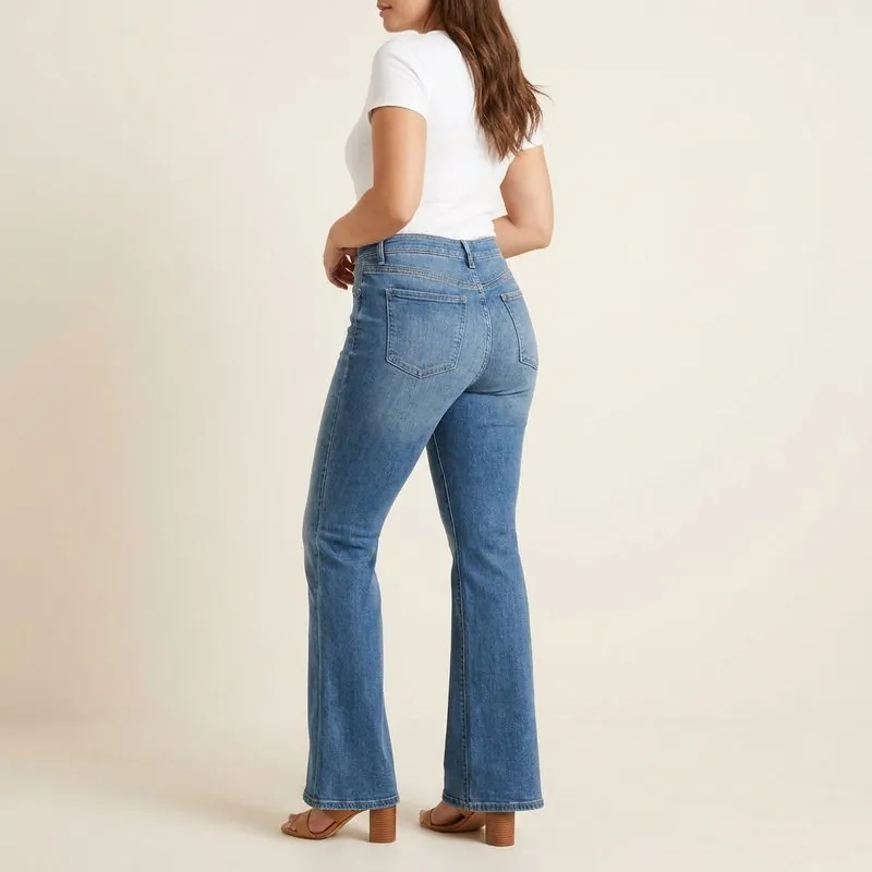 Flare jeans worn by a woman with an hourglass figure, back view