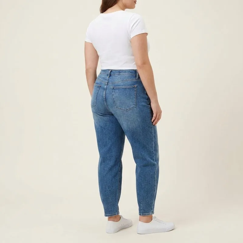 Barrel jeans worn by a woman with an inverted triangle body shape, back view