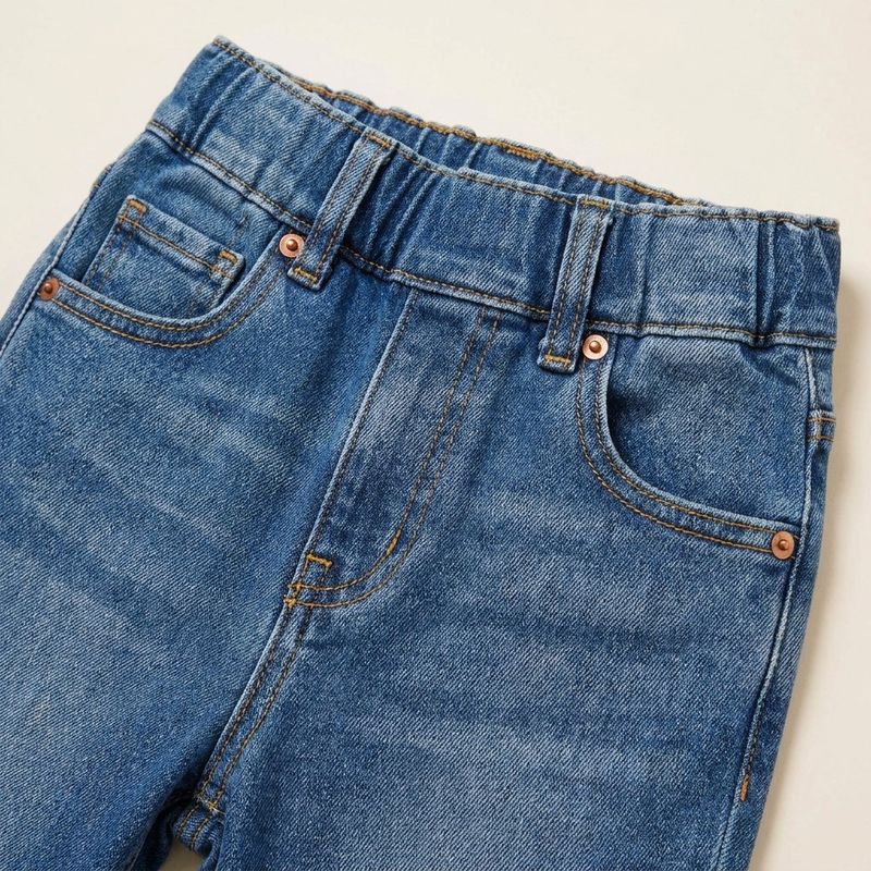 Close-up of an elastic pull-on waistband on children's jeans