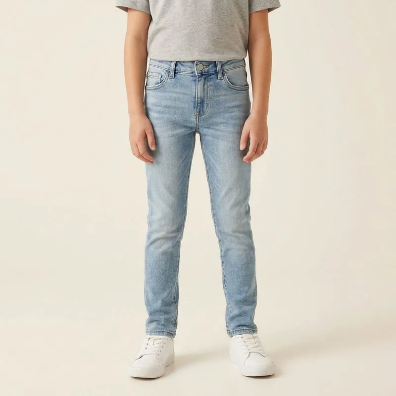Child wearing light wash slim jeans