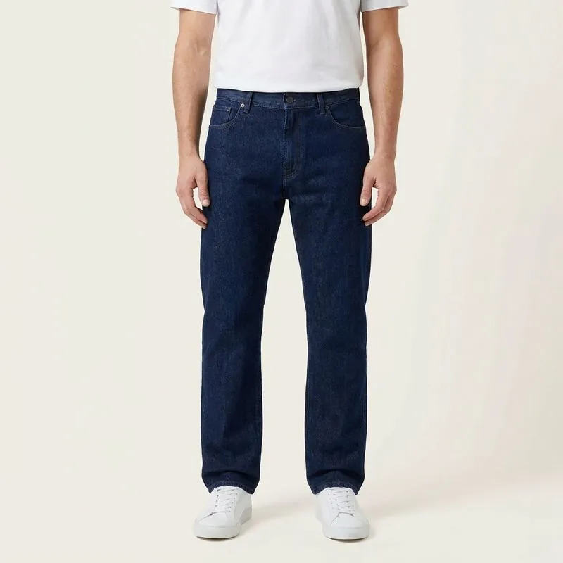 Model wearing dark straight-leg jeans with the hem at the top of the shoe