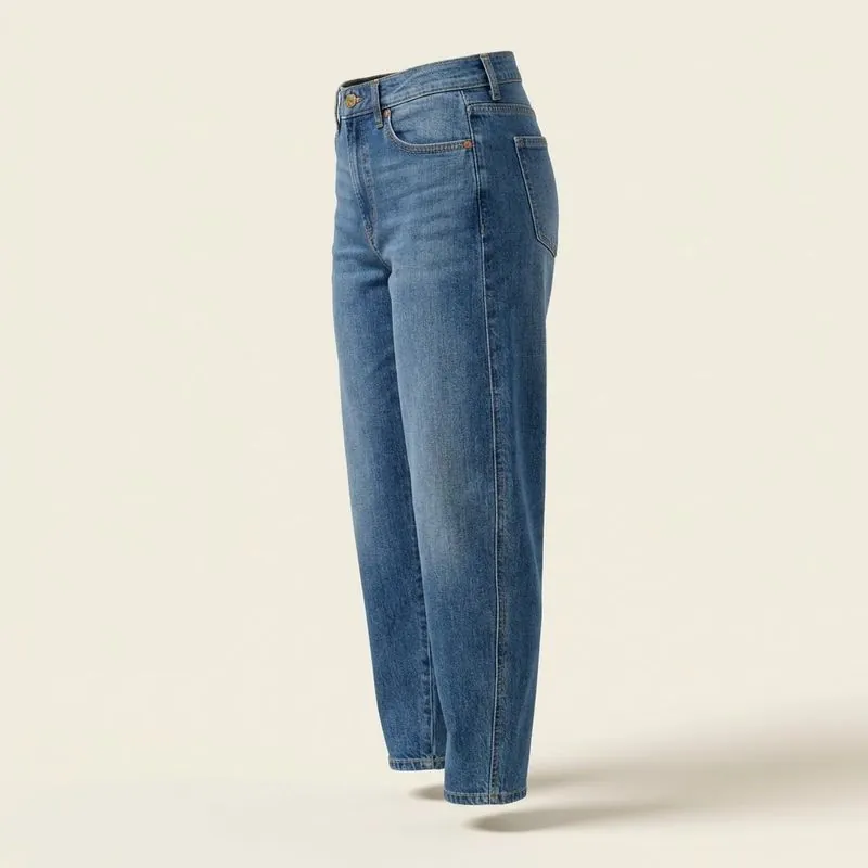 Side view of barrel jeans showing the leg curving out at the knee and in at the ankle