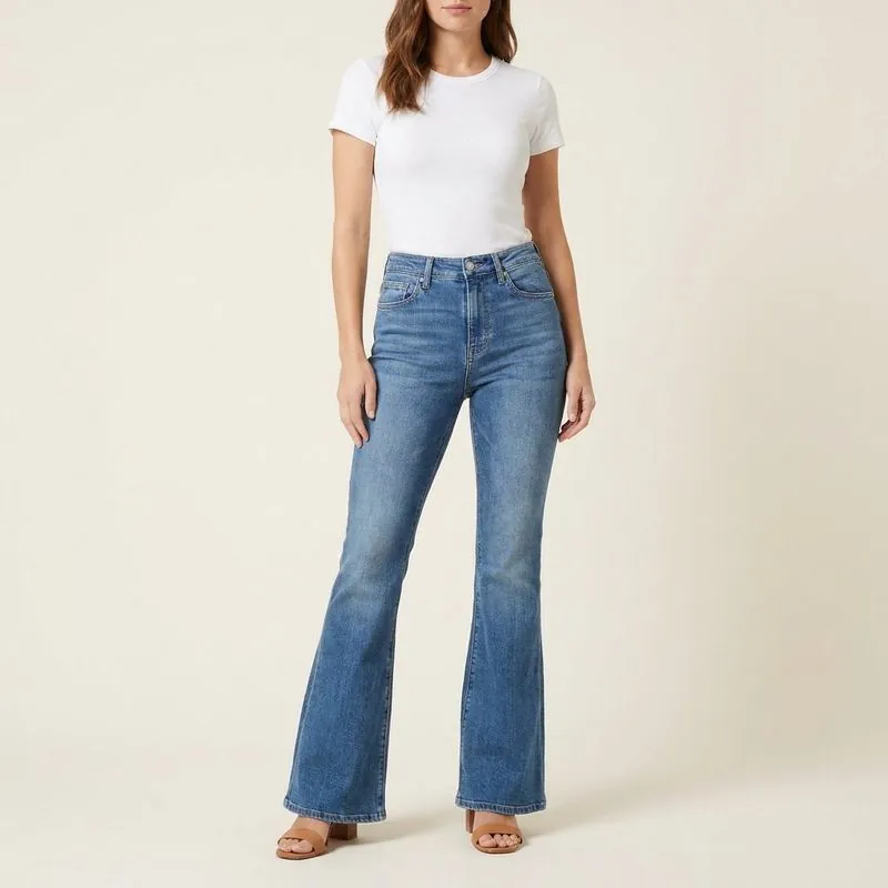 Flare jeans in mid wash, worn on a model